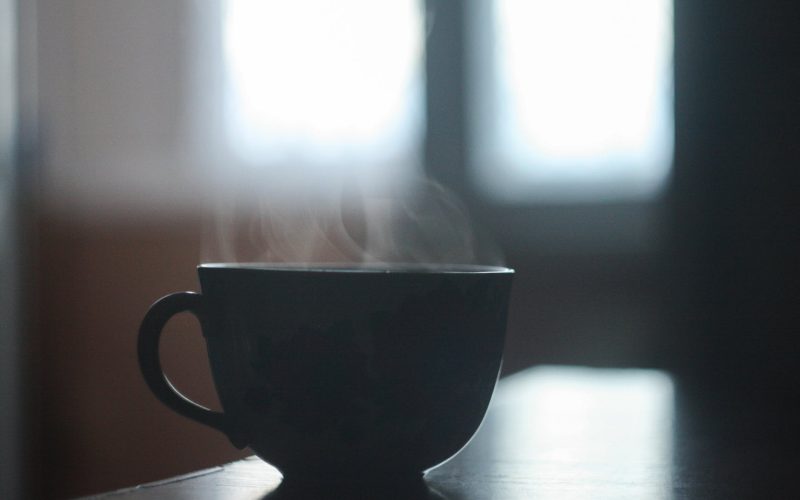 black ceramic cup with smoke above