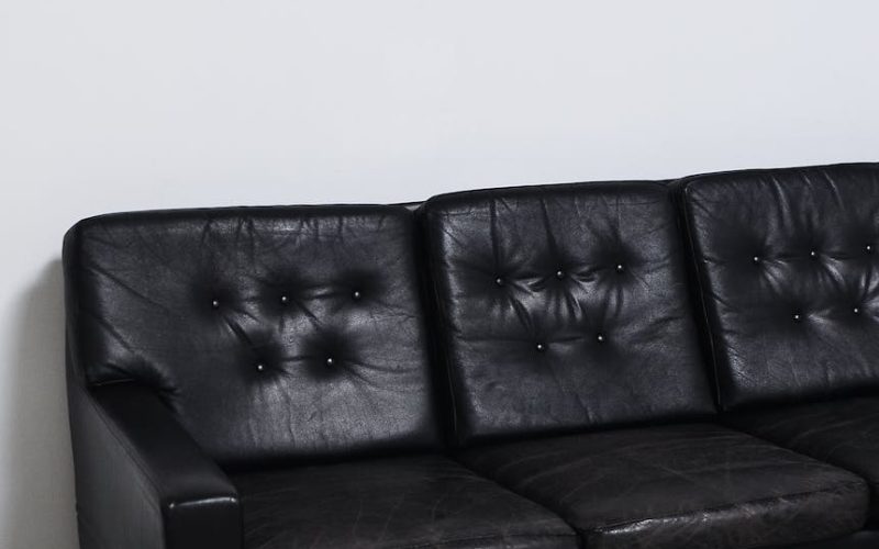 weathered black leather sofa in light room