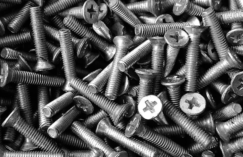 silver screw lot on brown wooden table