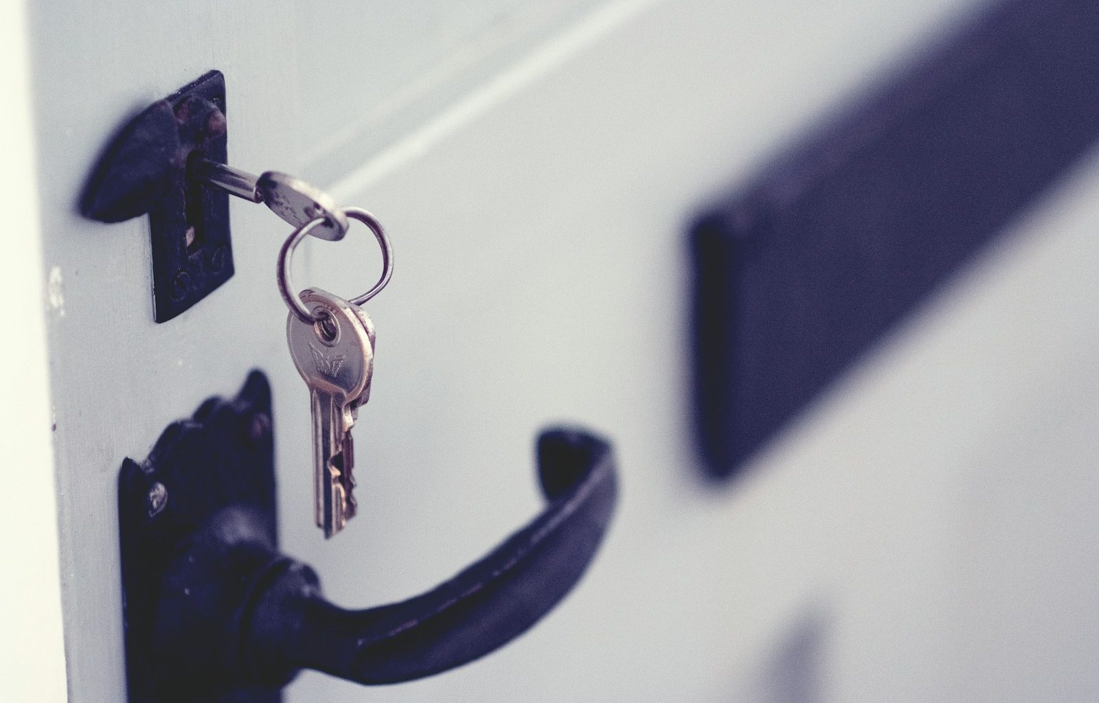 black and silver padlock on white door