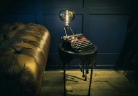 a table with a lamp on top of it next to a couch