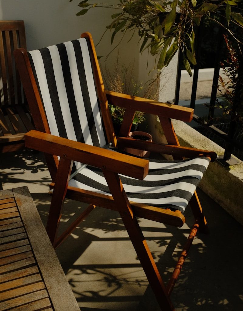 a wooden chair sitting on top of a wooden deck