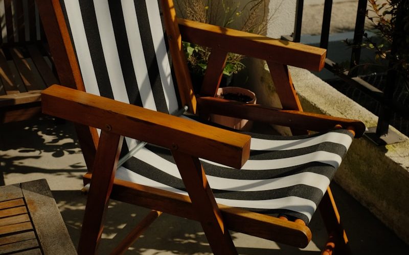 a wooden chair sitting on top of a wooden deck