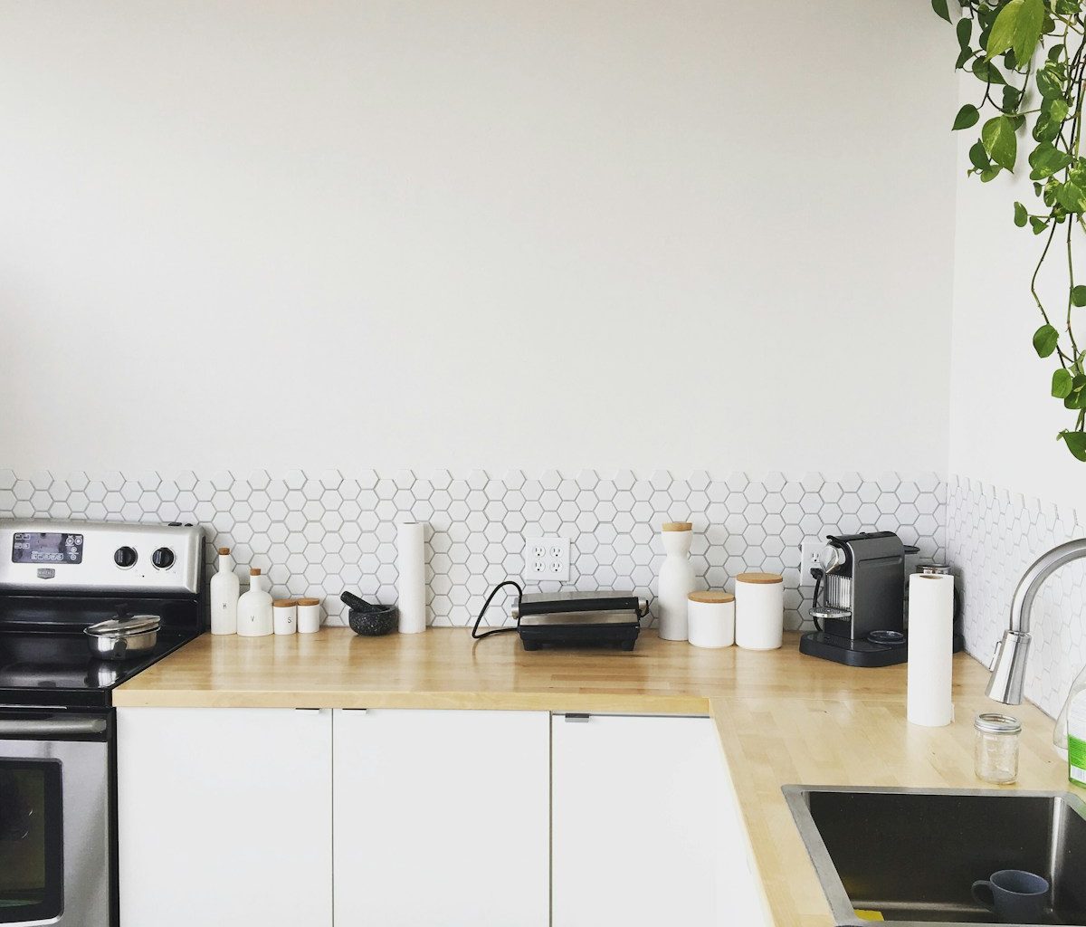 black coffee maker on brown wooden kitchen table