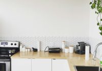 black coffee maker on brown wooden kitchen table