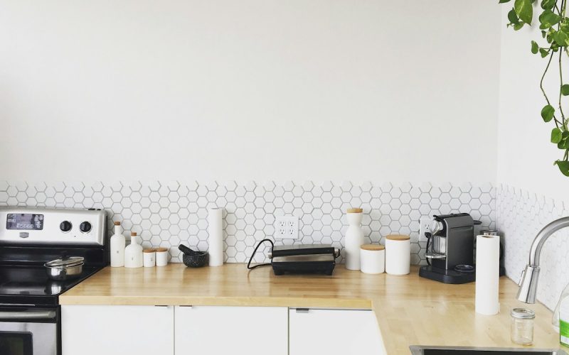 black coffee maker on brown wooden kitchen table